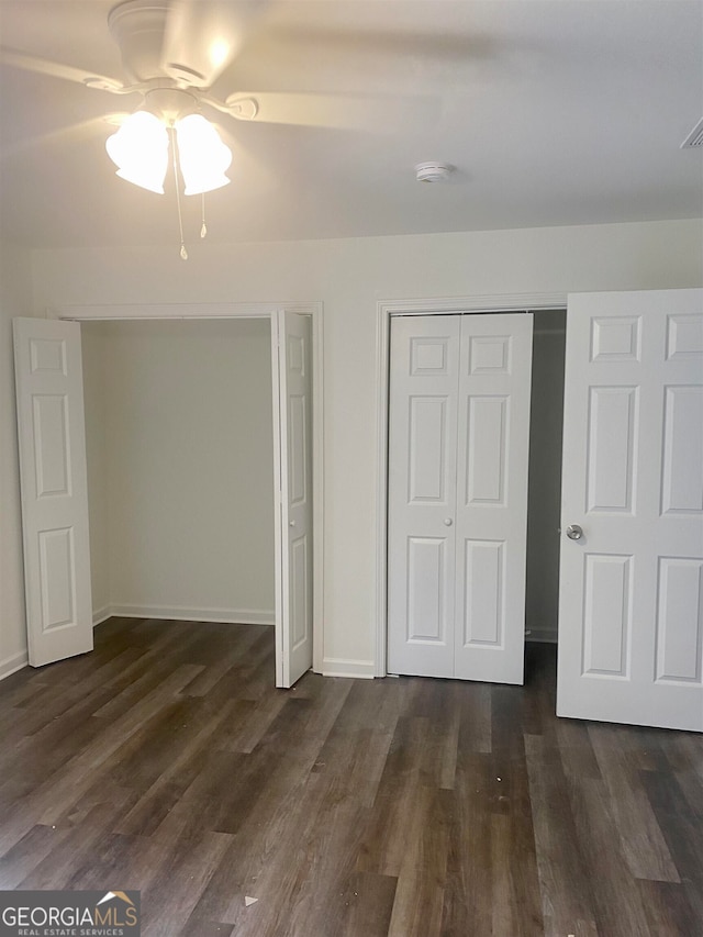 unfurnished bedroom with a closet, ceiling fan, and dark hardwood / wood-style flooring