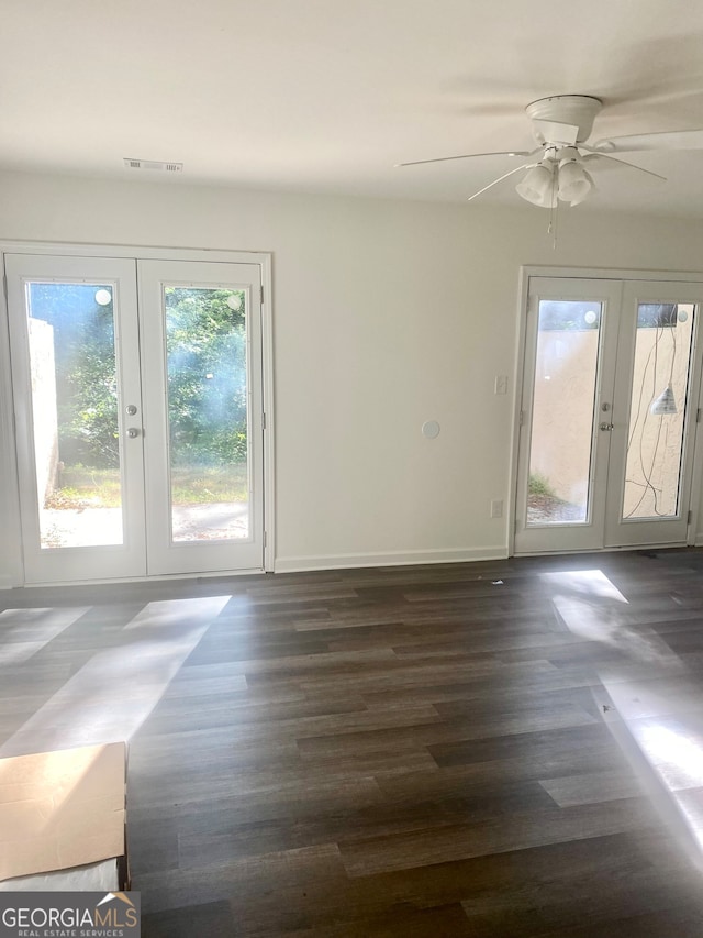 unfurnished room with french doors, dark hardwood / wood-style flooring, and ceiling fan