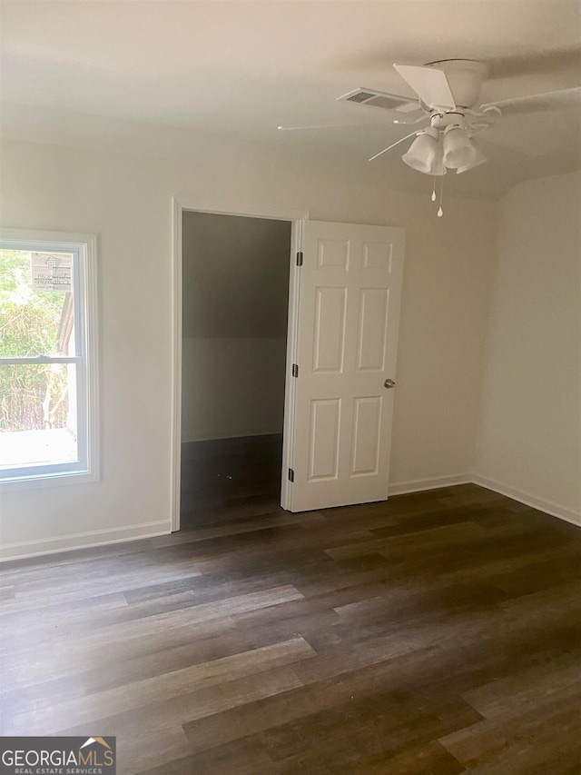 empty room featuring dark hardwood / wood-style flooring and ceiling fan