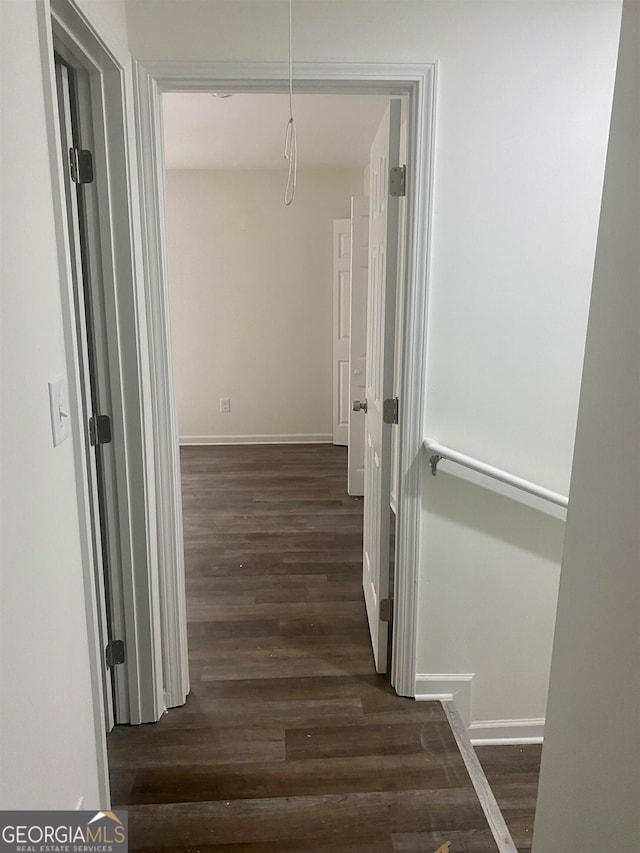 corridor featuring dark hardwood / wood-style floors