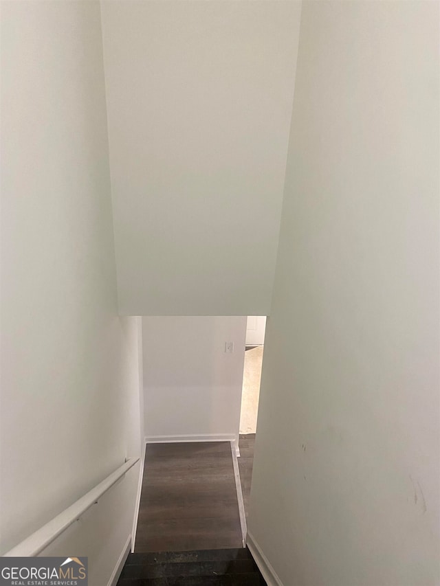 staircase with hardwood / wood-style floors