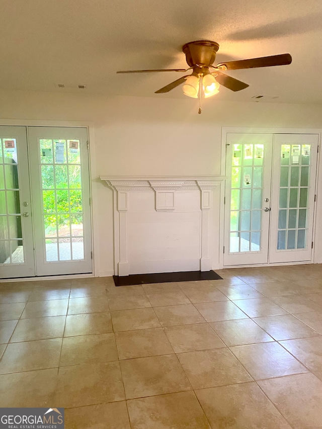 interior space with ceiling fan, light tile patterned floors, and french doors