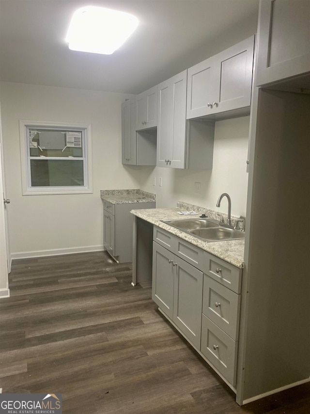 kitchen featuring sink, gray cabinets, and dark hardwood / wood-style flooring