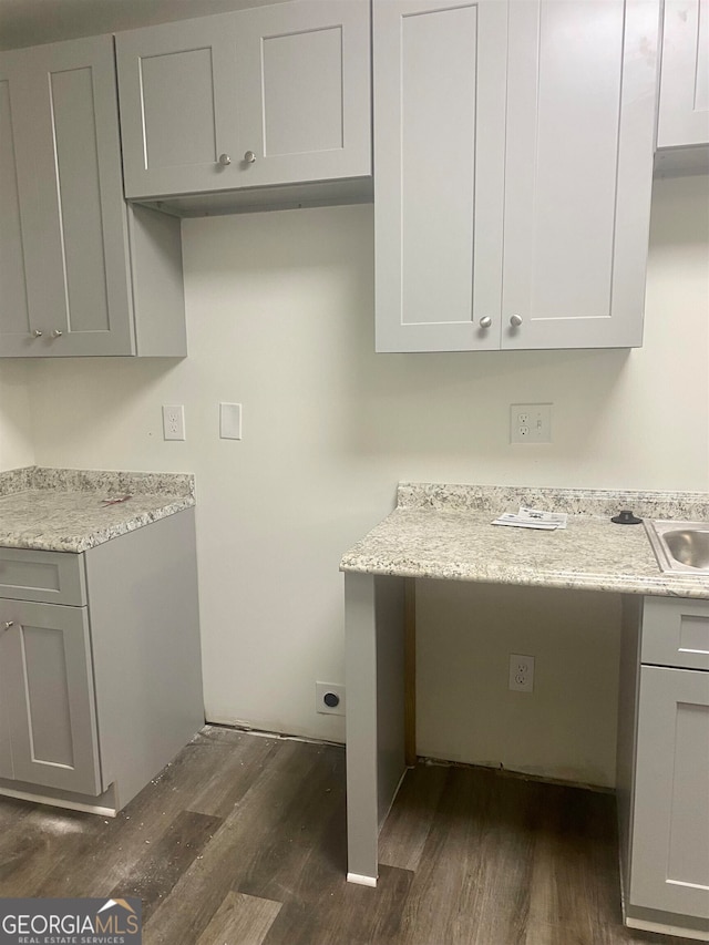 clothes washing area with dark hardwood / wood-style flooring