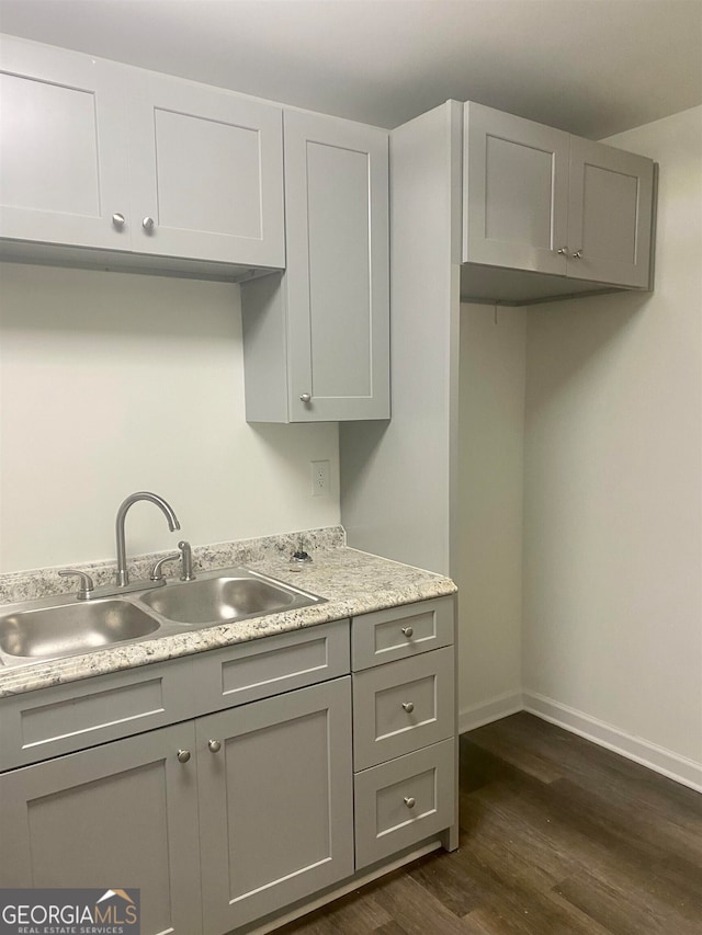 kitchen with gray cabinets, dark hardwood / wood-style floors, and sink