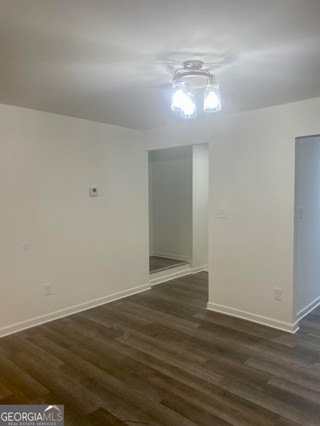 unfurnished room featuring dark hardwood / wood-style flooring