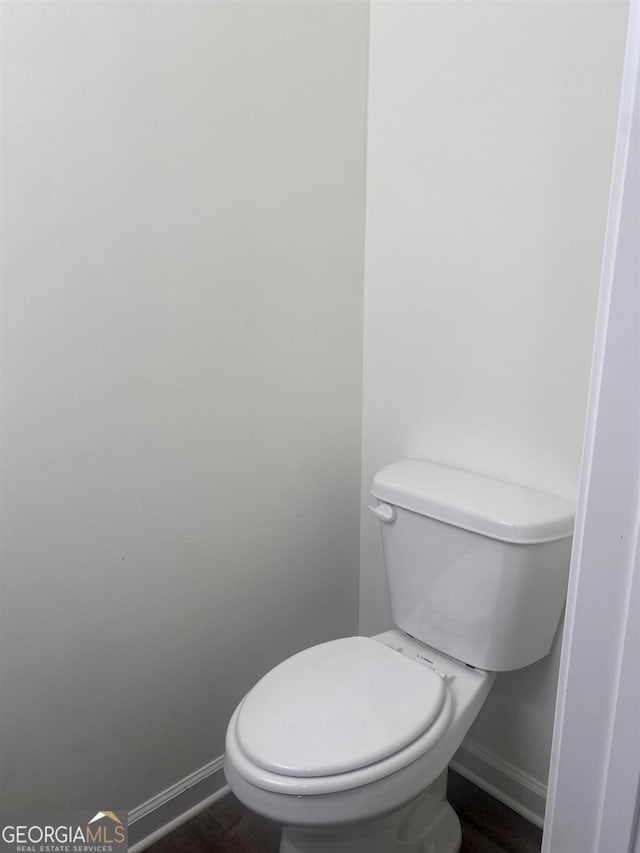 bathroom with toilet and hardwood / wood-style flooring