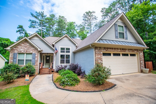 view of front of property featuring brick siding, roof with shingles, driveway, and a standing seam roof