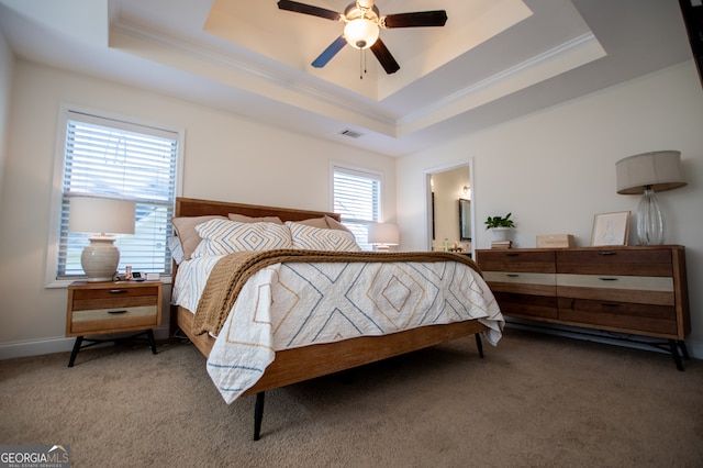 carpeted bedroom with connected bathroom, ceiling fan, and a tray ceiling