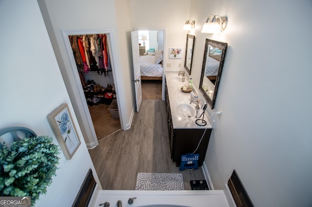 bathroom featuring a sink, baseboards, and wood finished floors