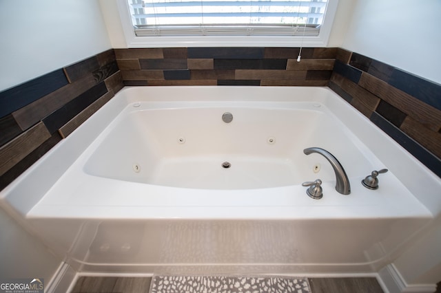 bathroom featuring a tub with jets