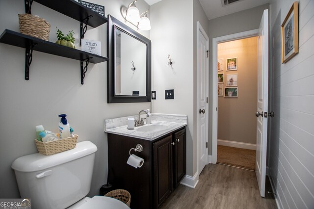 bathroom featuring vanity, toilet, and hardwood / wood-style flooring