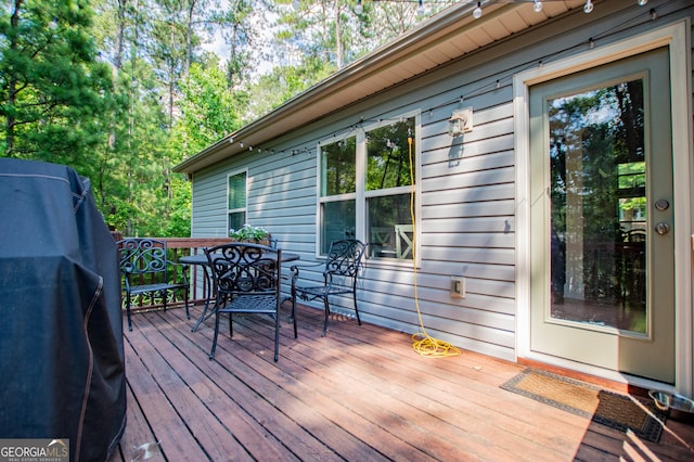 wooden deck featuring outdoor dining area