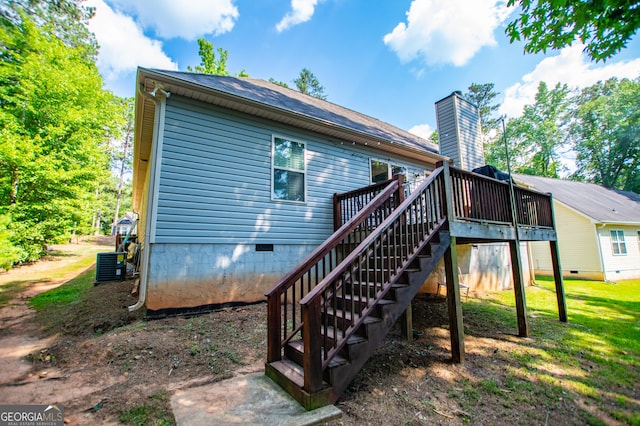 rear view of house with stairs, central AC, a lawn, a deck, and crawl space