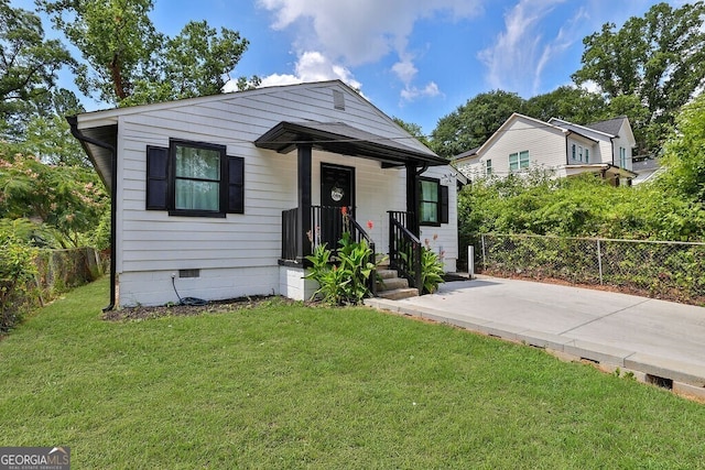 bungalow-style home with a front lawn