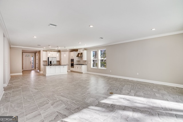 unfurnished living room featuring crown molding