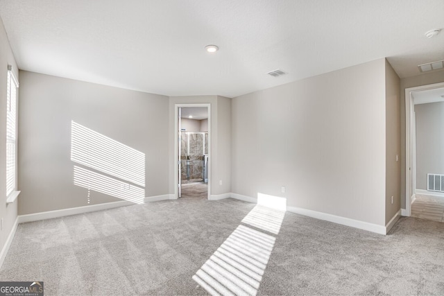 unfurnished room with light colored carpet