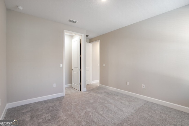 unfurnished bedroom featuring light colored carpet