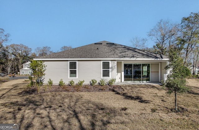 back of property featuring a patio and a yard