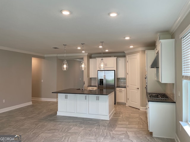 kitchen featuring crown molding, stainless steel appliances, hanging light fixtures, white cabinets, and an island with sink