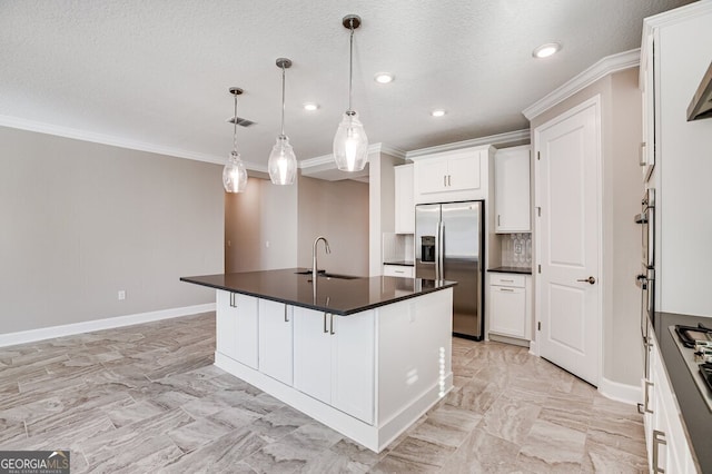 kitchen with appliances with stainless steel finishes, a kitchen breakfast bar, white cabinets, sink, and a kitchen island with sink