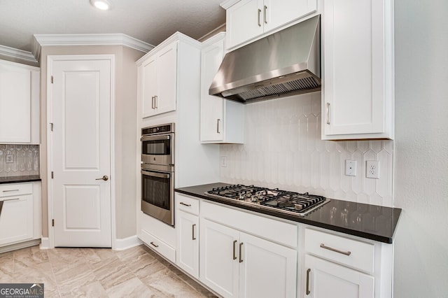 kitchen featuring white cabinetry, ornamental molding, tasteful backsplash, and stainless steel appliances