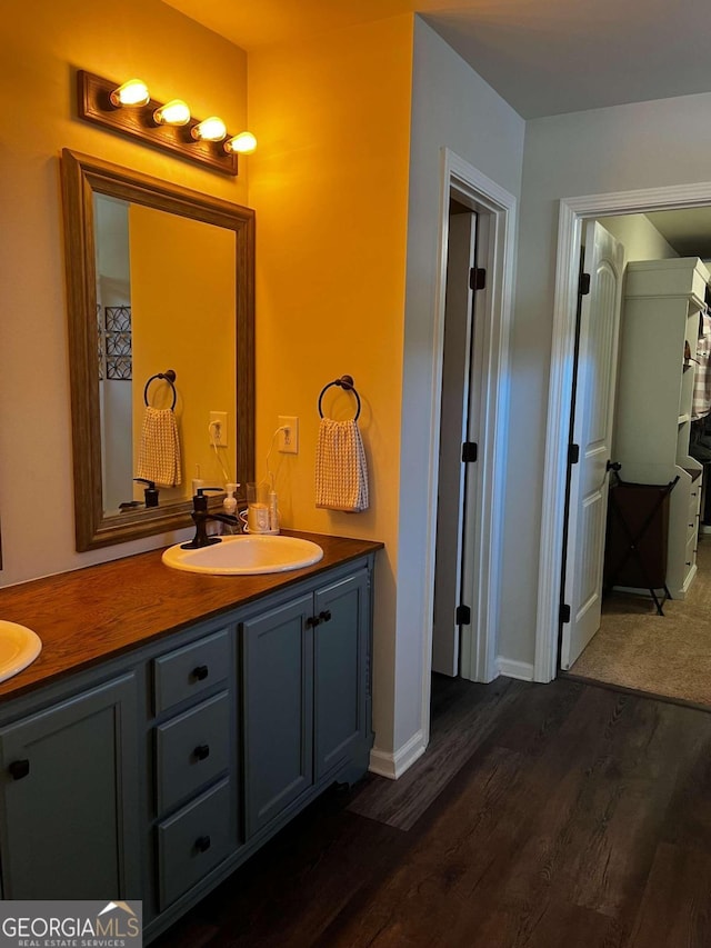 bathroom with hardwood / wood-style floors and vanity