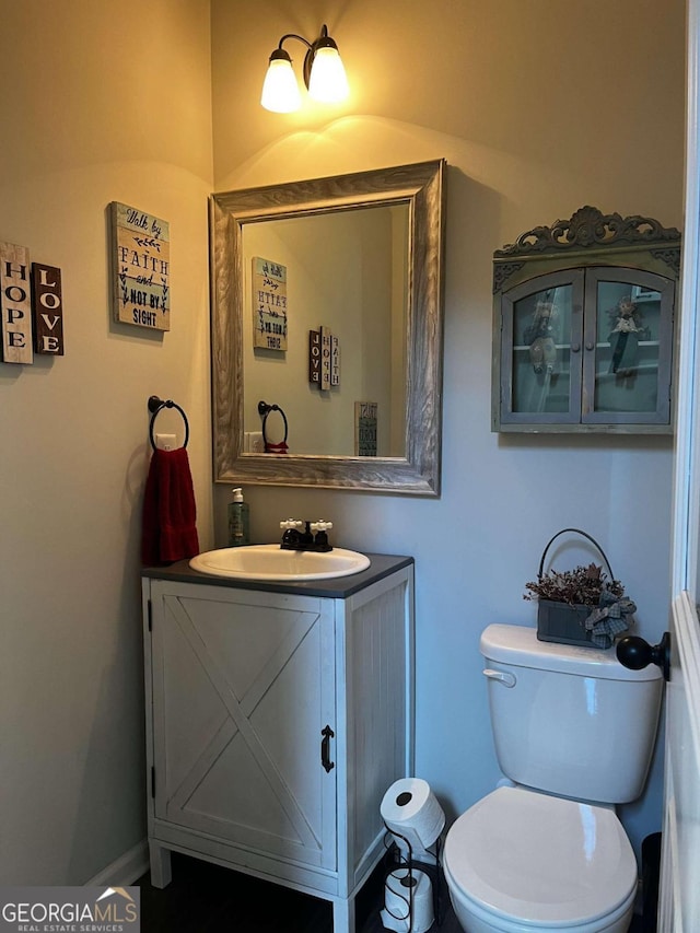 bathroom featuring toilet and vanity