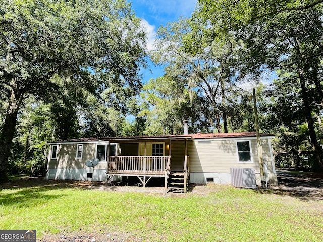 view of front of house featuring cooling unit, a front yard, and a deck