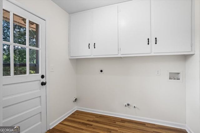 washroom featuring cabinets, hookup for an electric dryer, dark hardwood / wood-style flooring, hookup for a washing machine, and gas dryer hookup