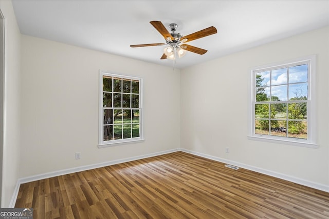 spare room featuring ceiling fan and hardwood / wood-style flooring