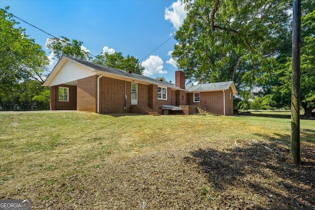 back of property featuring a lawn