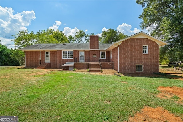 back of property with a lawn