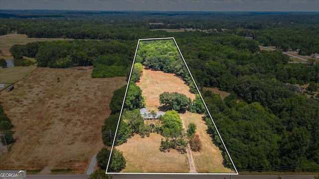 birds eye view of property with a rural view