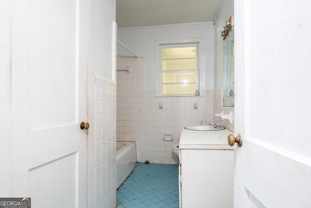 full bathroom with a textured ceiling, vanity, bathing tub / shower combination, toilet, and ornamental molding