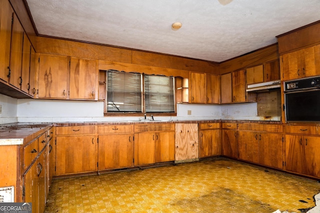 kitchen featuring a textured ceiling and black oven