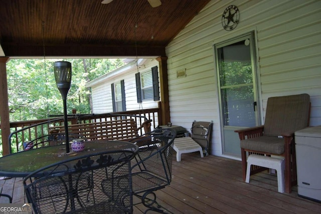 wooden deck featuring outdoor dining space and ceiling fan