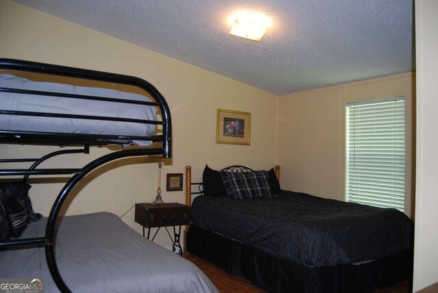 bedroom featuring a textured ceiling and lofted ceiling