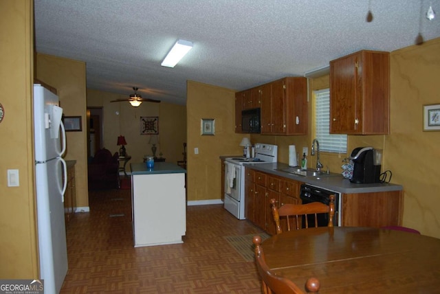 kitchen featuring black appliances, dark parquet flooring, ceiling fan, sink, and vaulted ceiling