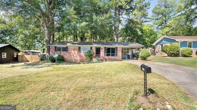 ranch-style home with a front lawn