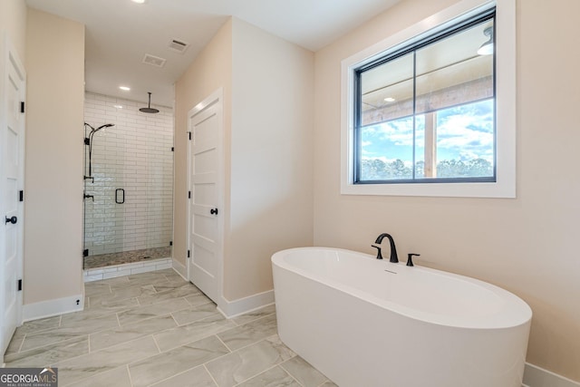 bathroom featuring independent shower and bath