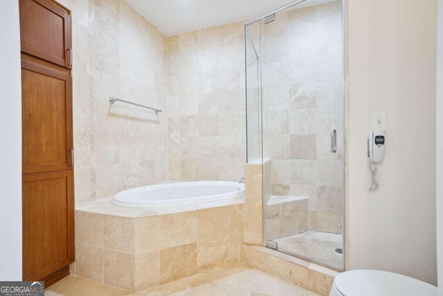 bathroom with shower with separate bathtub, toilet, and tile patterned floors