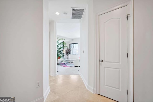 corridor featuring light tile patterned floors