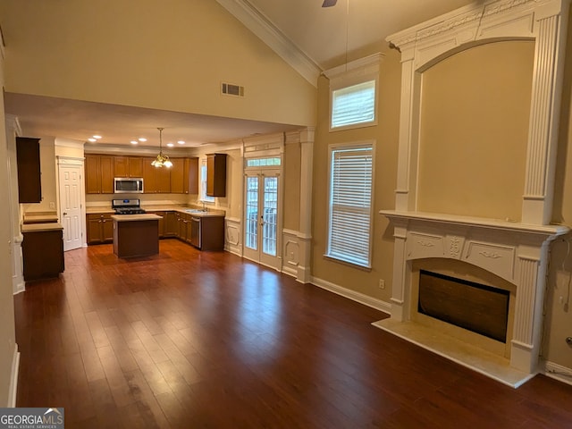 unfurnished living room with sink, french doors, high vaulted ceiling, crown molding, and dark hardwood / wood-style flooring