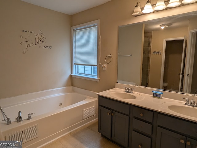 full bathroom featuring vanity, tile patterned flooring, toilet, and separate shower and tub