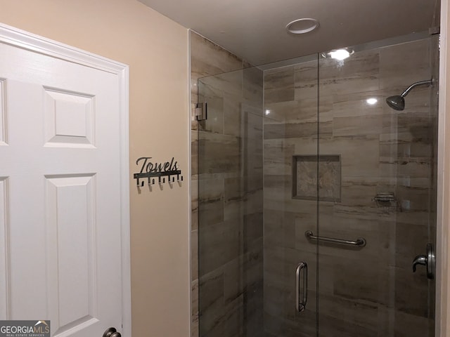 bathroom with a shower with shower door