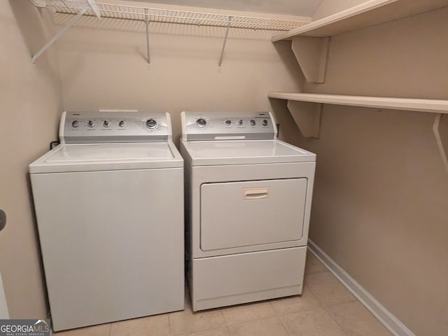 washroom with washer and dryer and light tile patterned floors