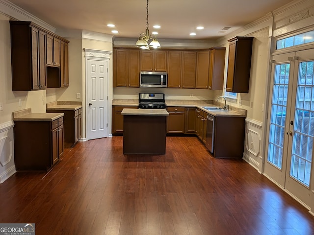 kitchen featuring a kitchen island, sink, stainless steel appliances, and dark hardwood / wood-style flooring