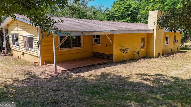 back of house featuring a patio and a yard