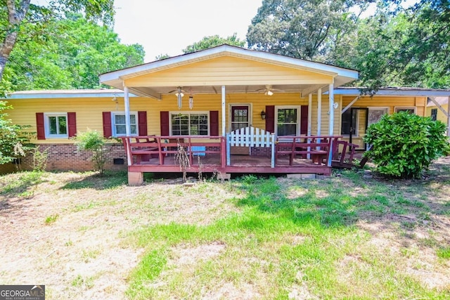 rear view of property featuring a wooden deck and ceiling fan